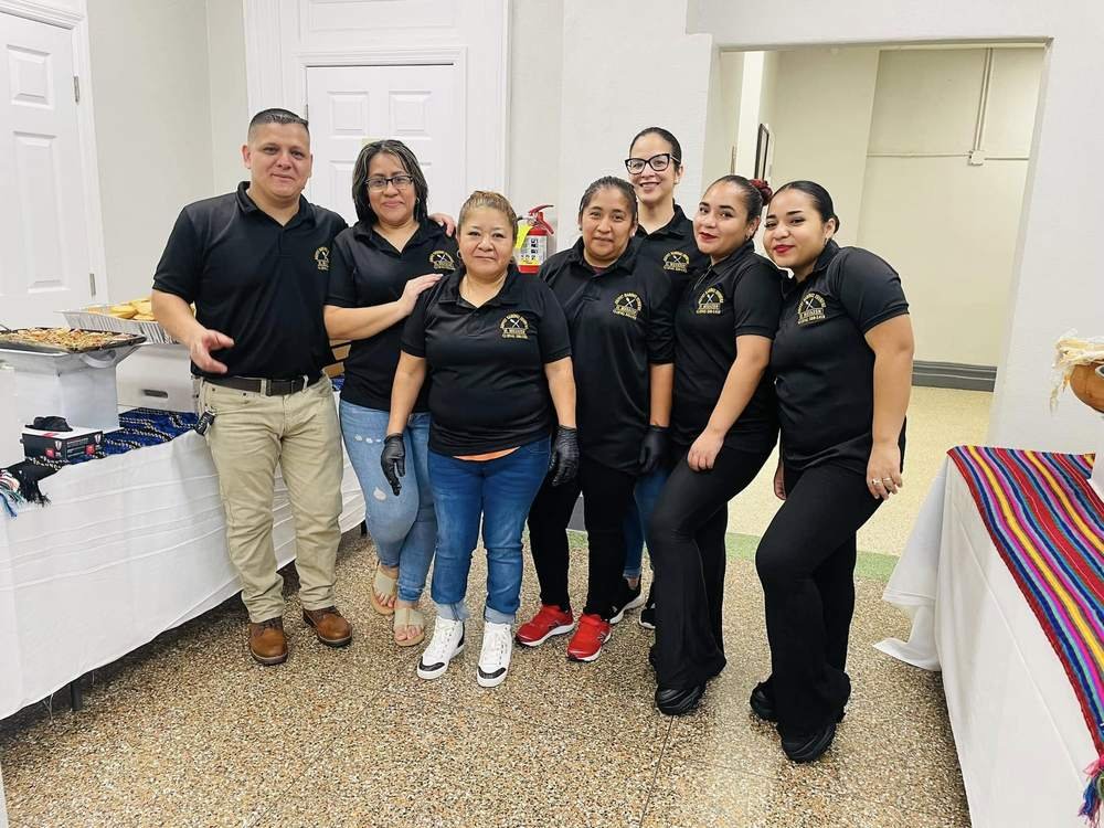 The Buffet Ramirez Eventos crew in uniform at an event