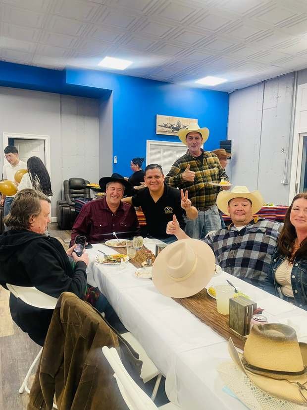 Guests eating at a long table indoors