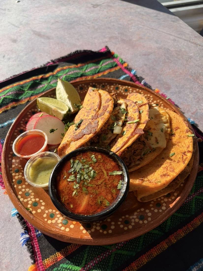Three tacos, served with their consomé.