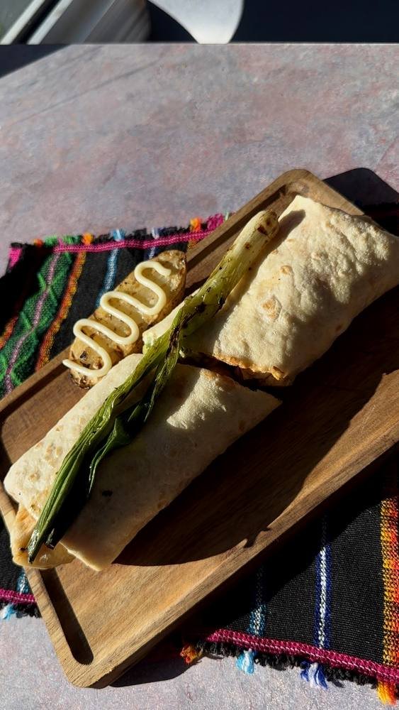 Hand-made, with beef, salsa, beans, avocado and scallions.