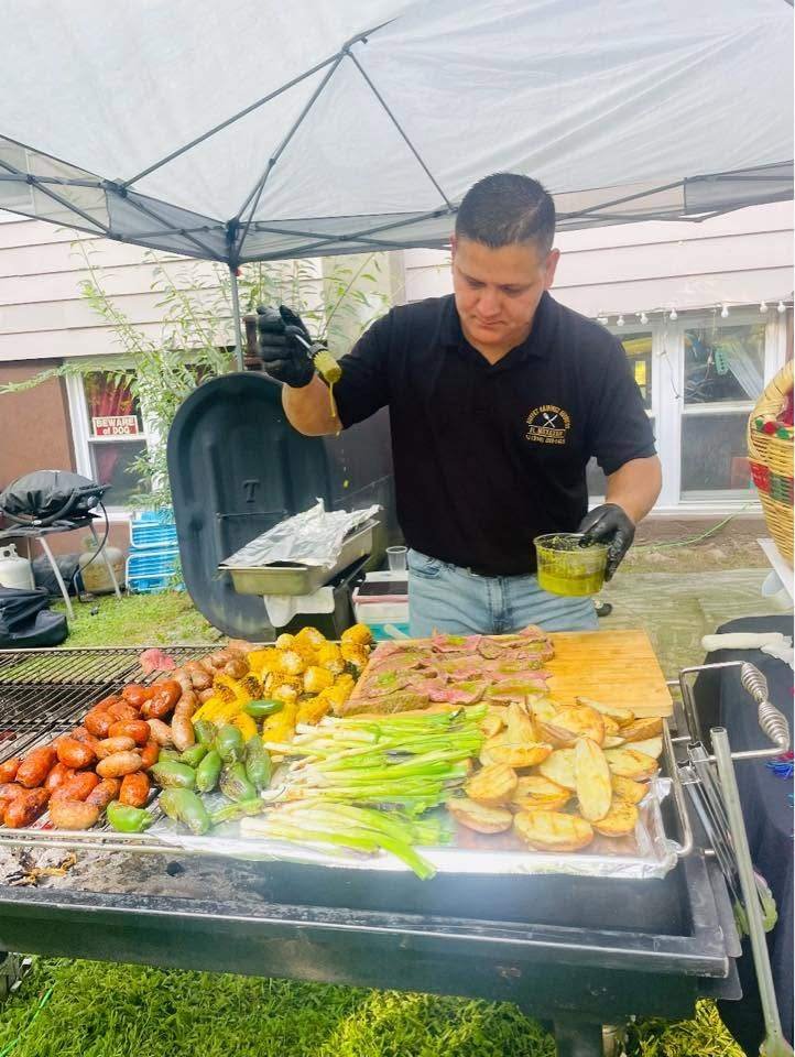Ronaldo basting meat on the grill under the tent